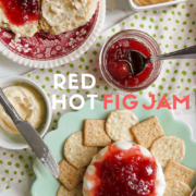 A plate of biscuit and jam with butter and a plate of cream cheese and jam with crackers.