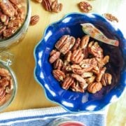 Roasted pecans in different containers for storage and serving.