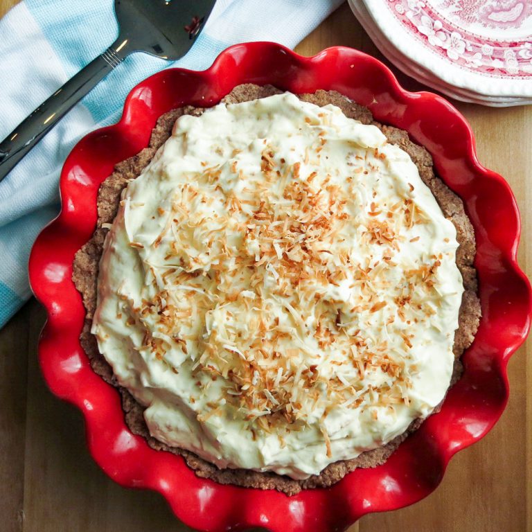 A Low Carb Coconut Pie in a red pie plate.