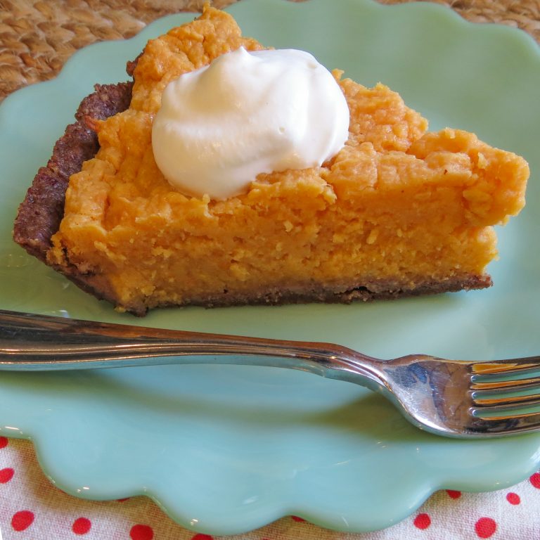 A piece of No Sugar Sweet Potato Pie with a dollop of whipped cream.