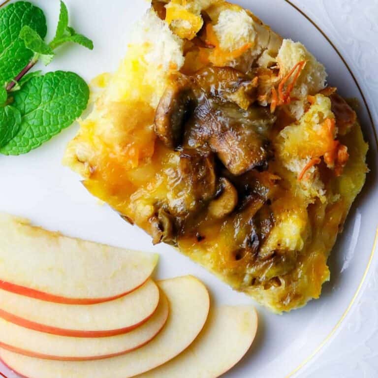 A plate of sliced apples, a casserole serving, and fresh mint.