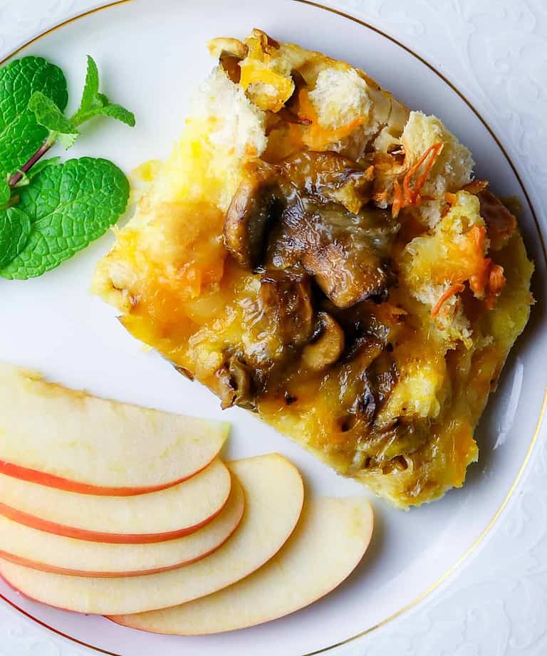 Plate of sliced apples and egg casserole with fresh mint.