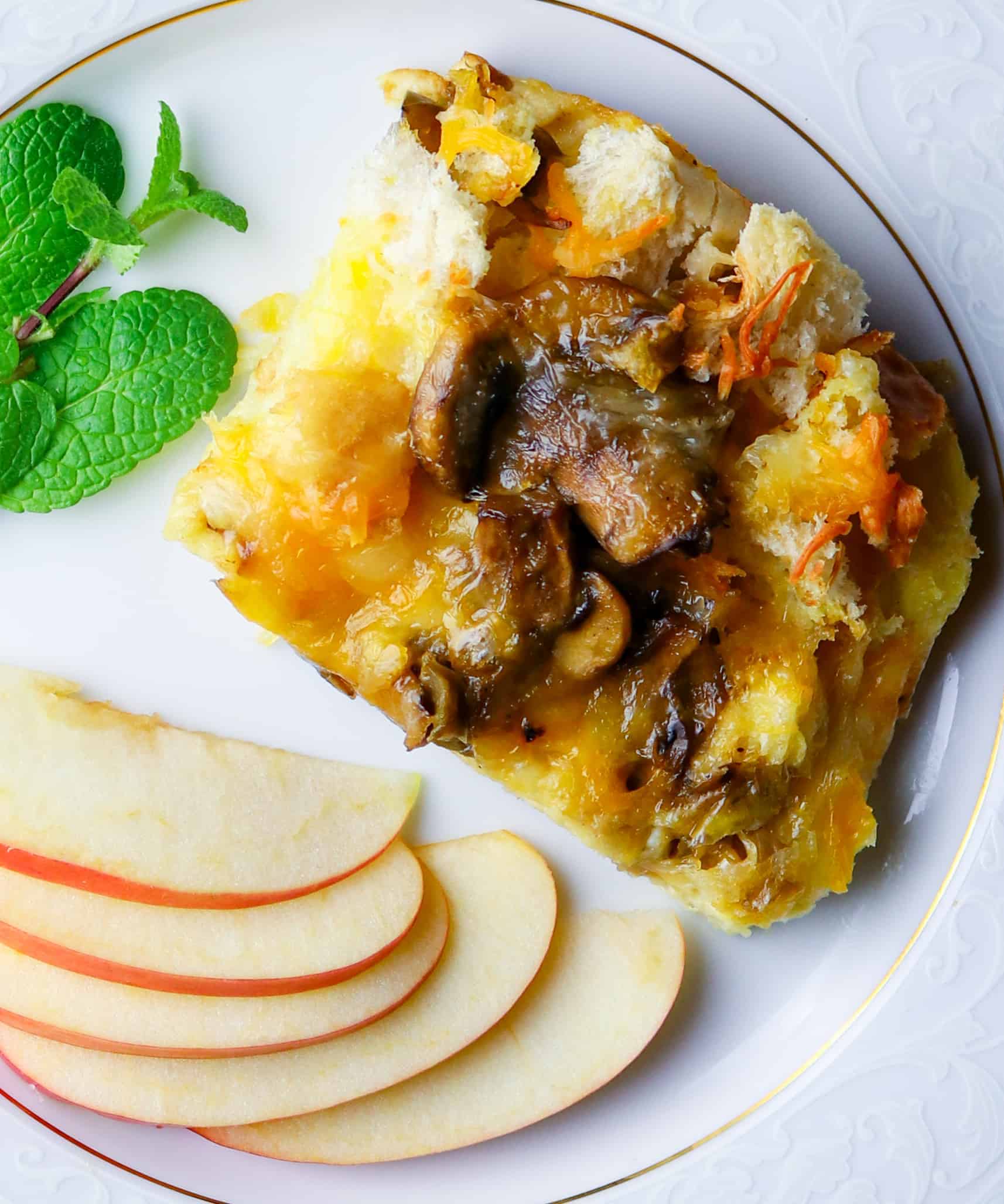 Plate of sliced apples and egg casserole with fresh mint.