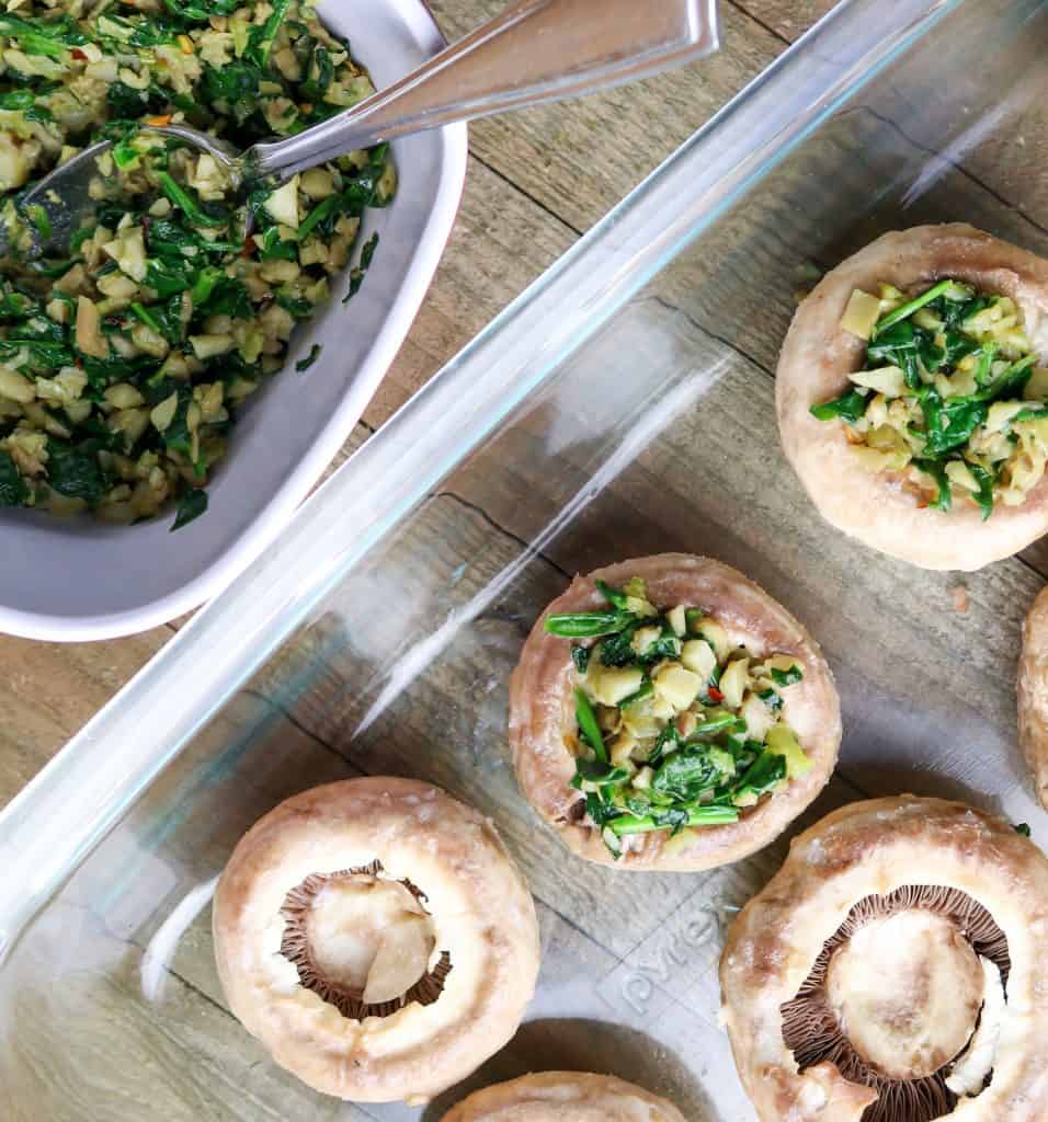 A glass baking dish filled with stuffed mushrooms.