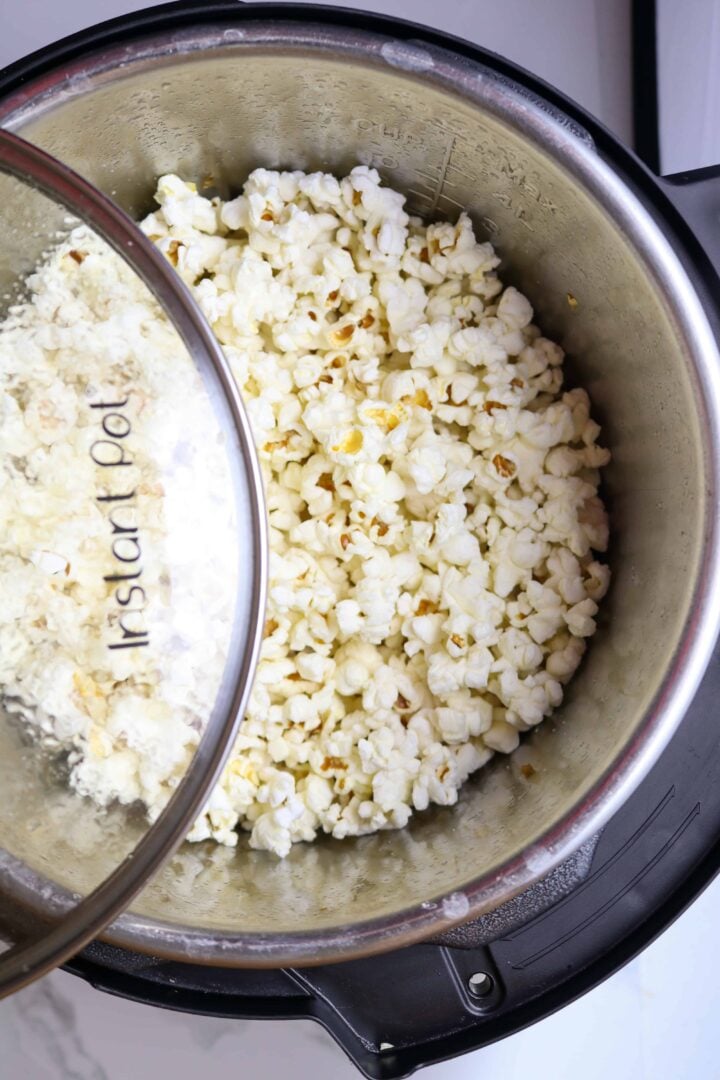 A pot of Popped corn with glass lid.