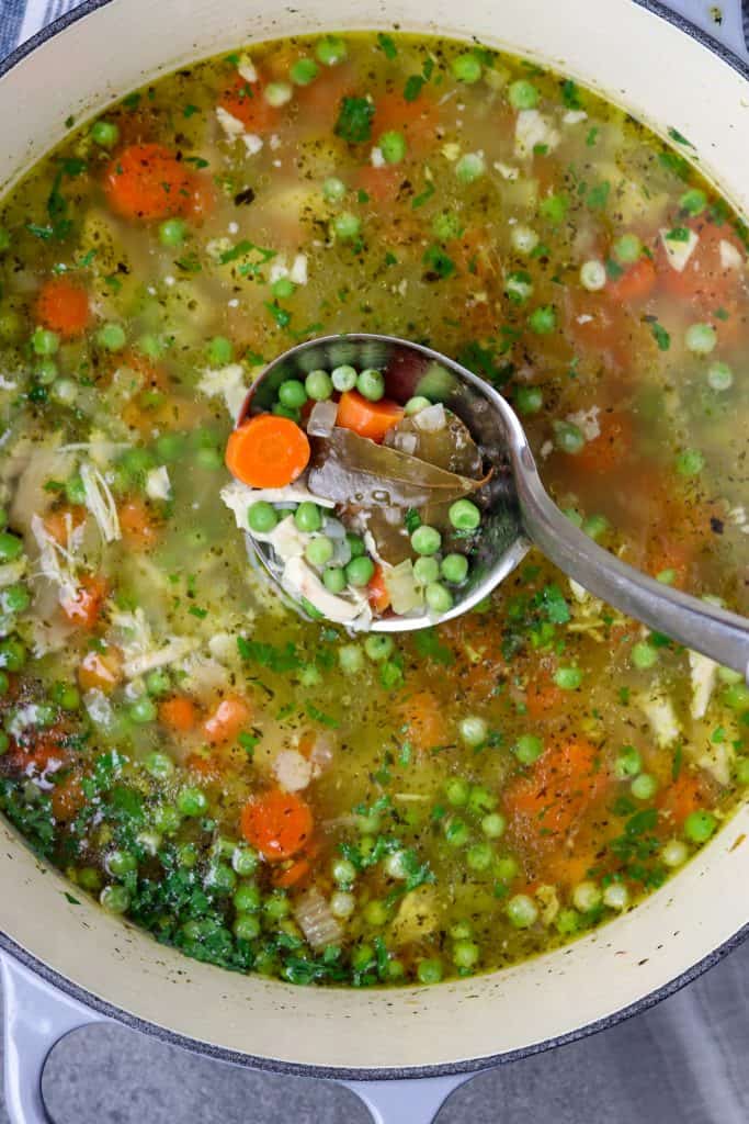 A pot of soup with a ladle in it.