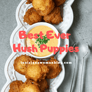 A long white platter of hush puppies and dipping sauce.
