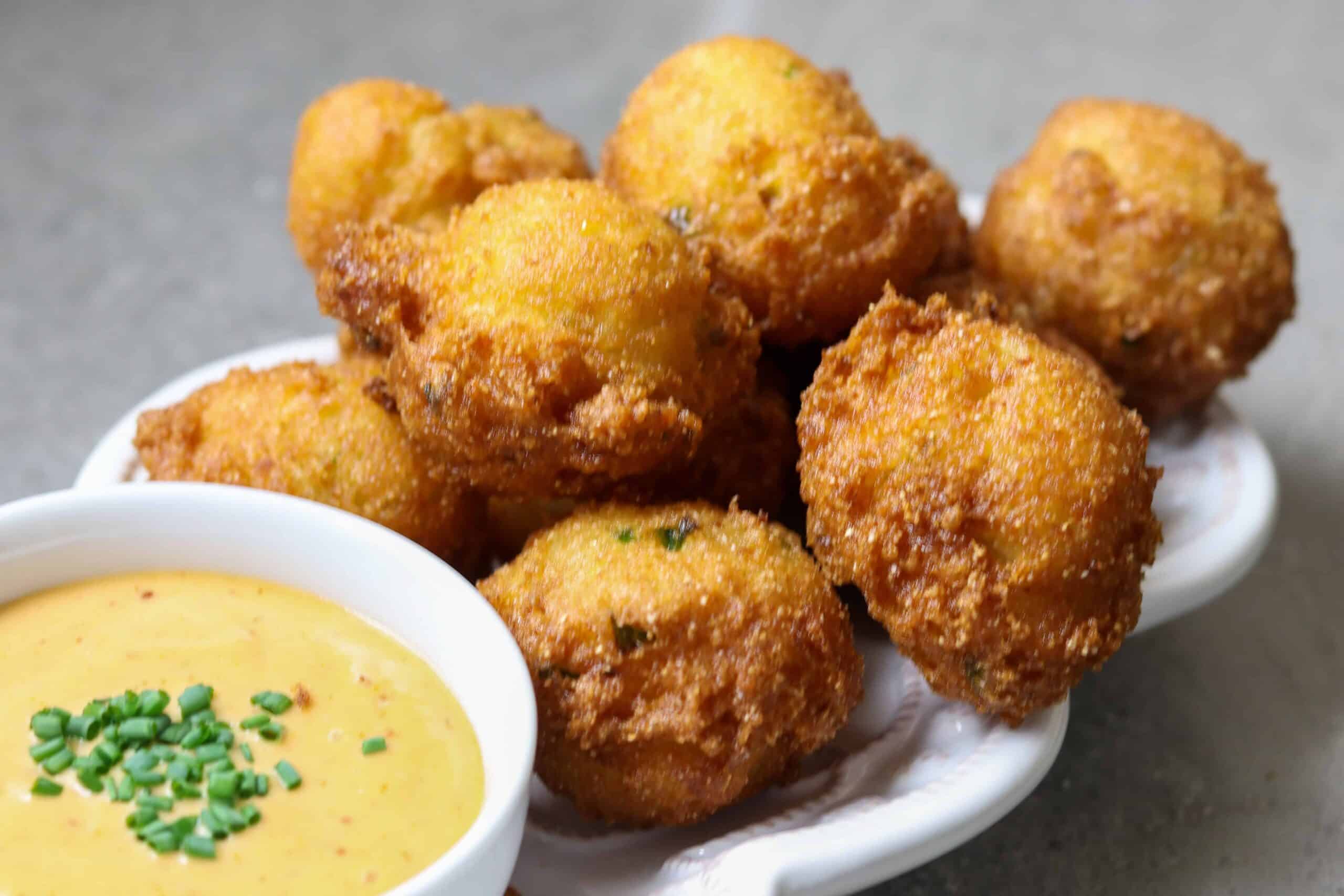 A plate of hush puppies and dip.