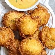 A plate of hush puppies and dip.
