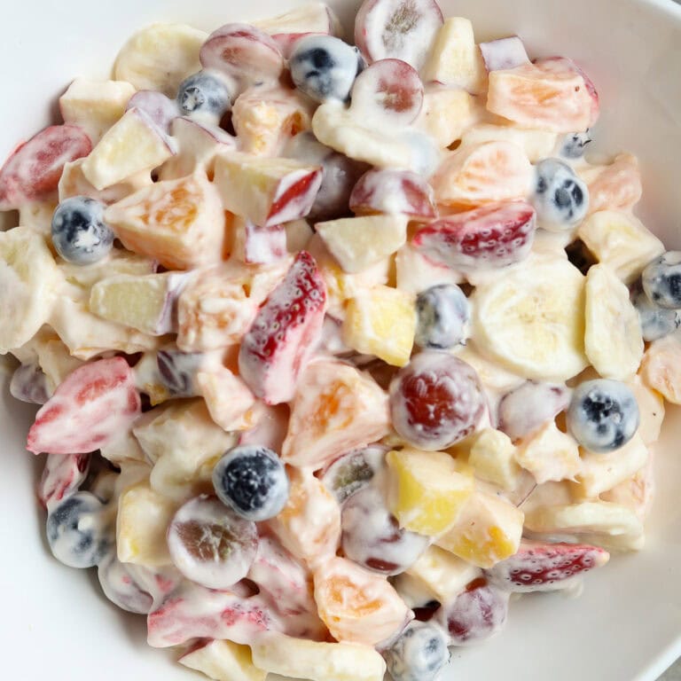 Fresh Fruit Salad in a white bowl.