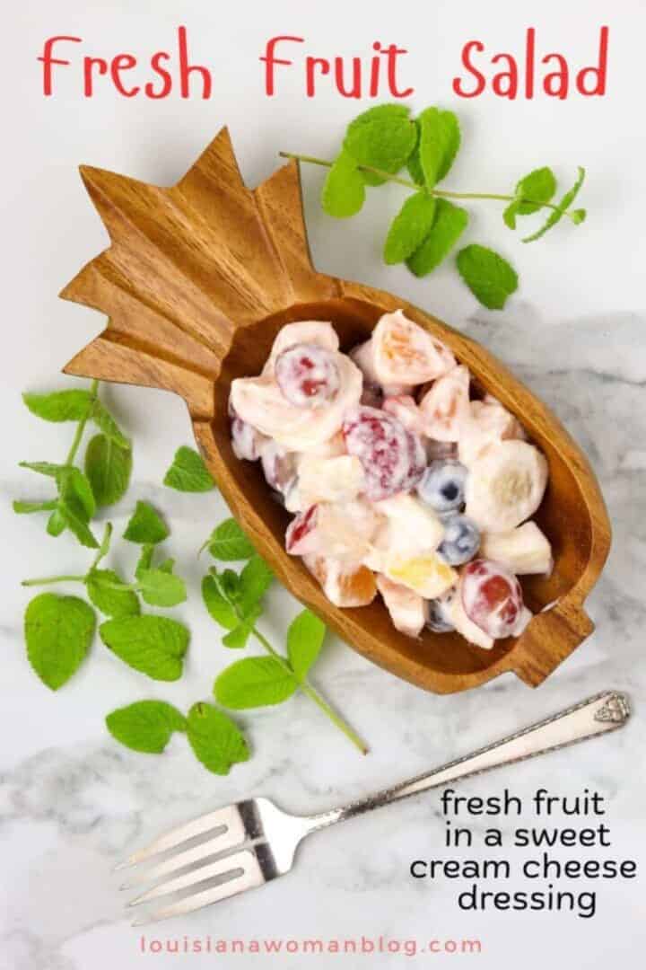 Fruit filled wooden pineapple bowl.