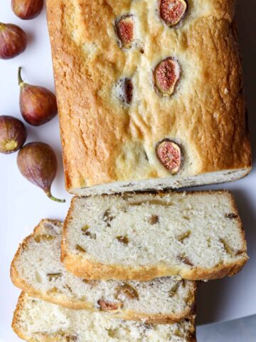 A loaf of fruit bread and figs.