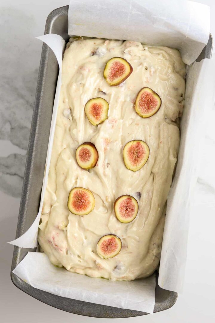 A loaf of unbaked fresh fig bread in a pan.