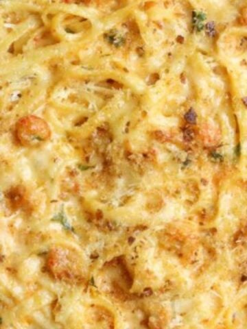 Baked crawfish fettuccine topped with cheese and breadcrumbs.