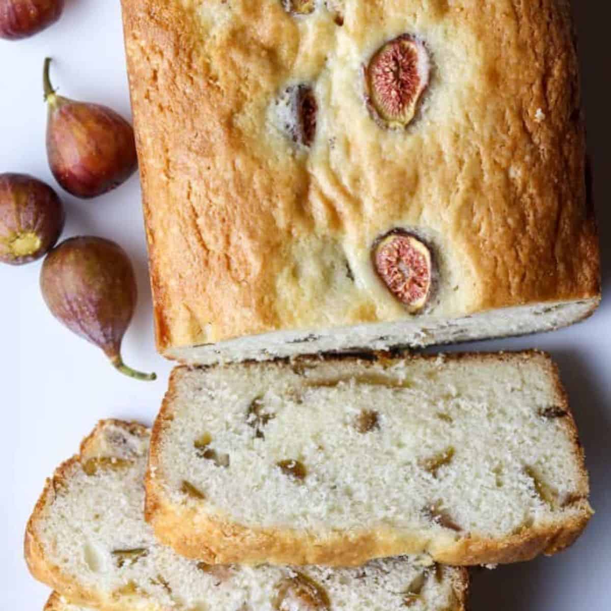 A loaf of fruit bread and figs.