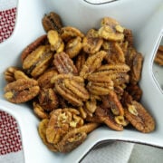 Roasted pecans in a star-shaped bowl.