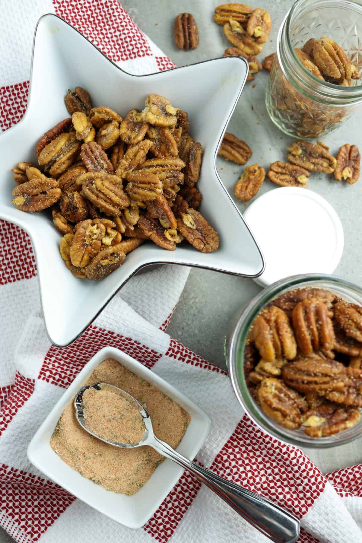 Roasted pecans in a star-shaped bowl and a jar.