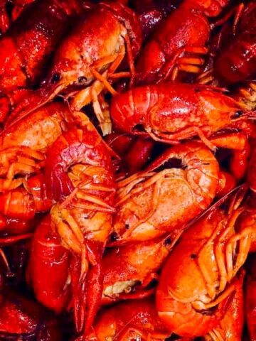 A group of boiled red crawfish on a platter.