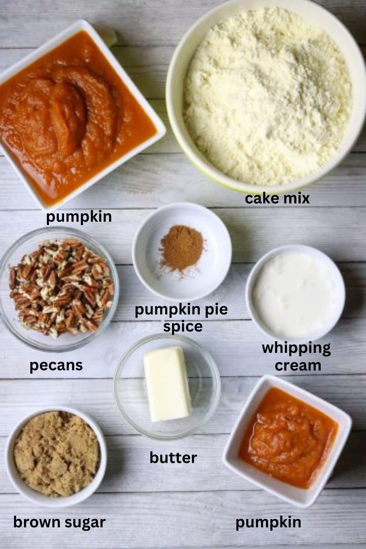 Ingredients of pumpkin, cake mix, nuts and others for a 2-ingredient pumpkin spice cake.
