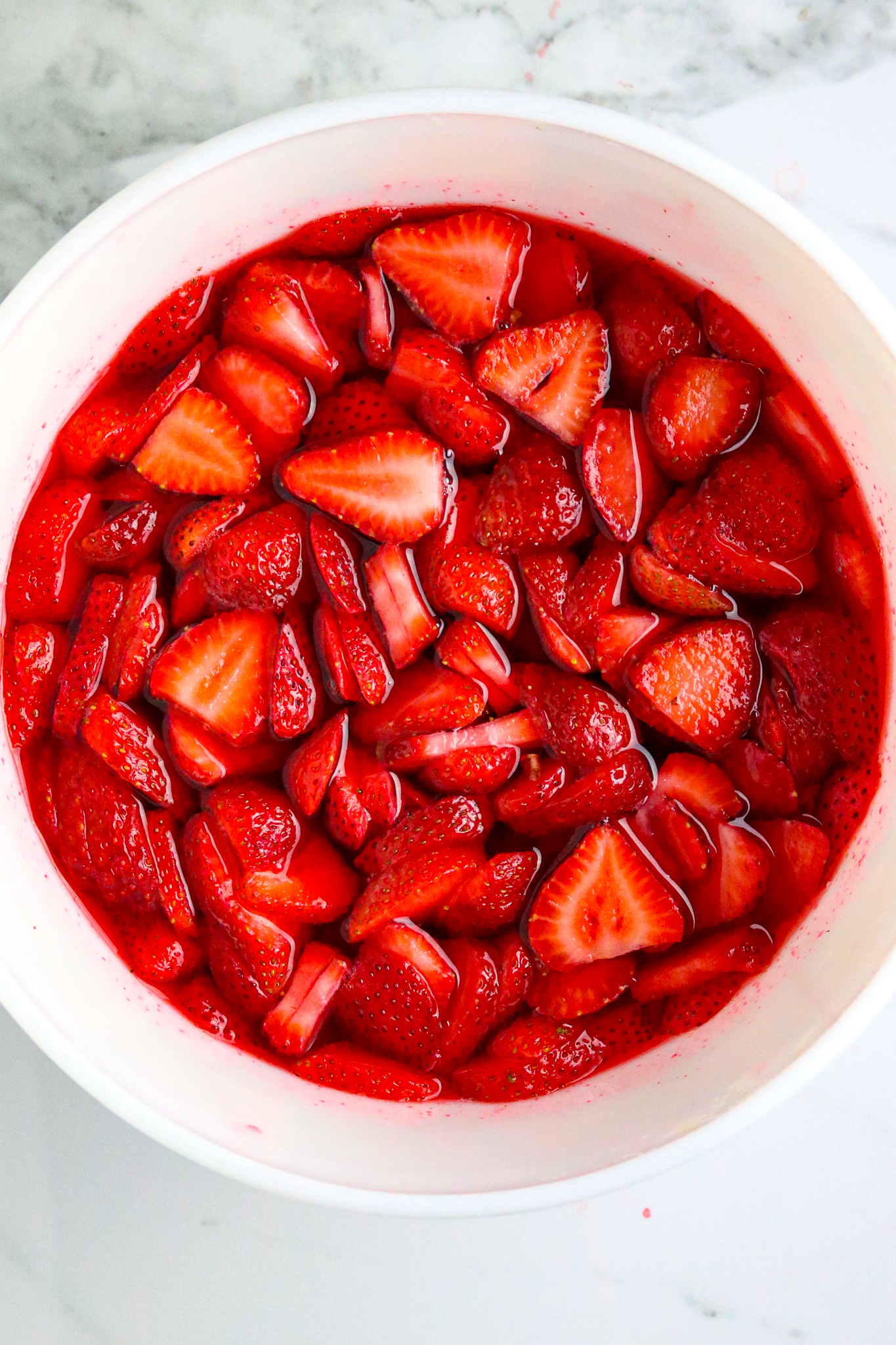 A bowl of sliced fresh strawberries.