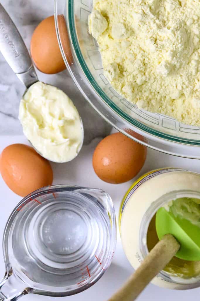 Ingredients of mayonnaise, water, eggs, and a bowl of cake mix.