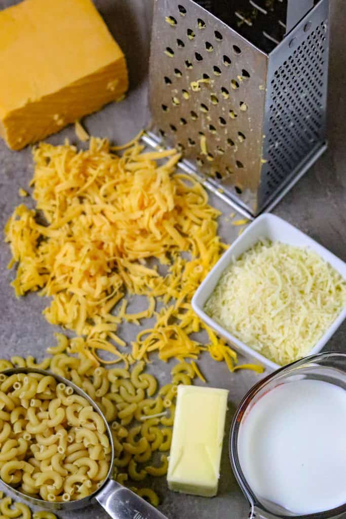 Ingredients of cheeses, dry macaroni, milk, and butter.