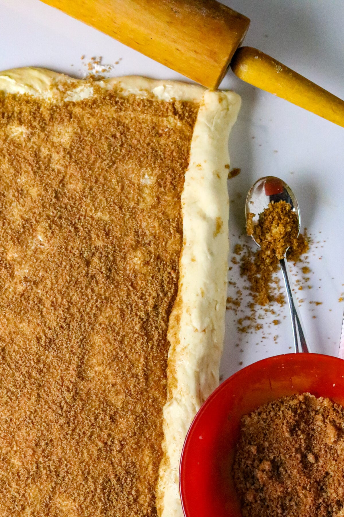 King Cake dough rolled out with a cinnamon, sugar, and butter spread.
