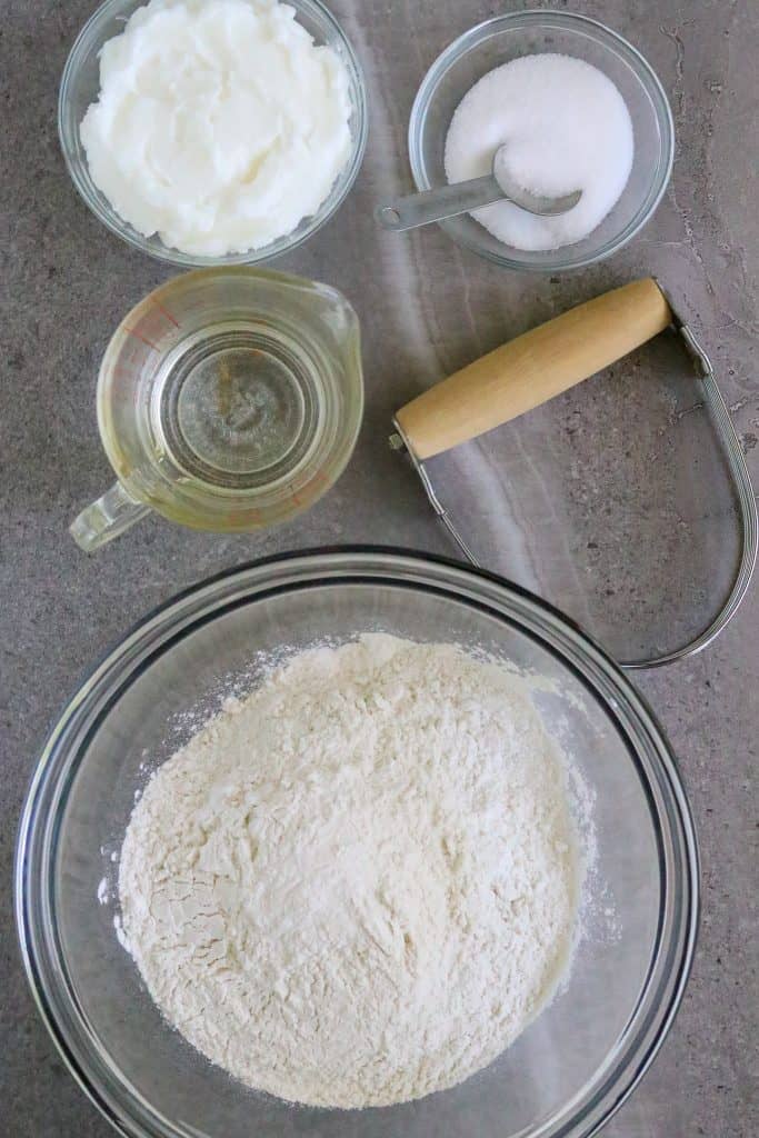Ingredients of flour, water, and shortening for pie crust making.