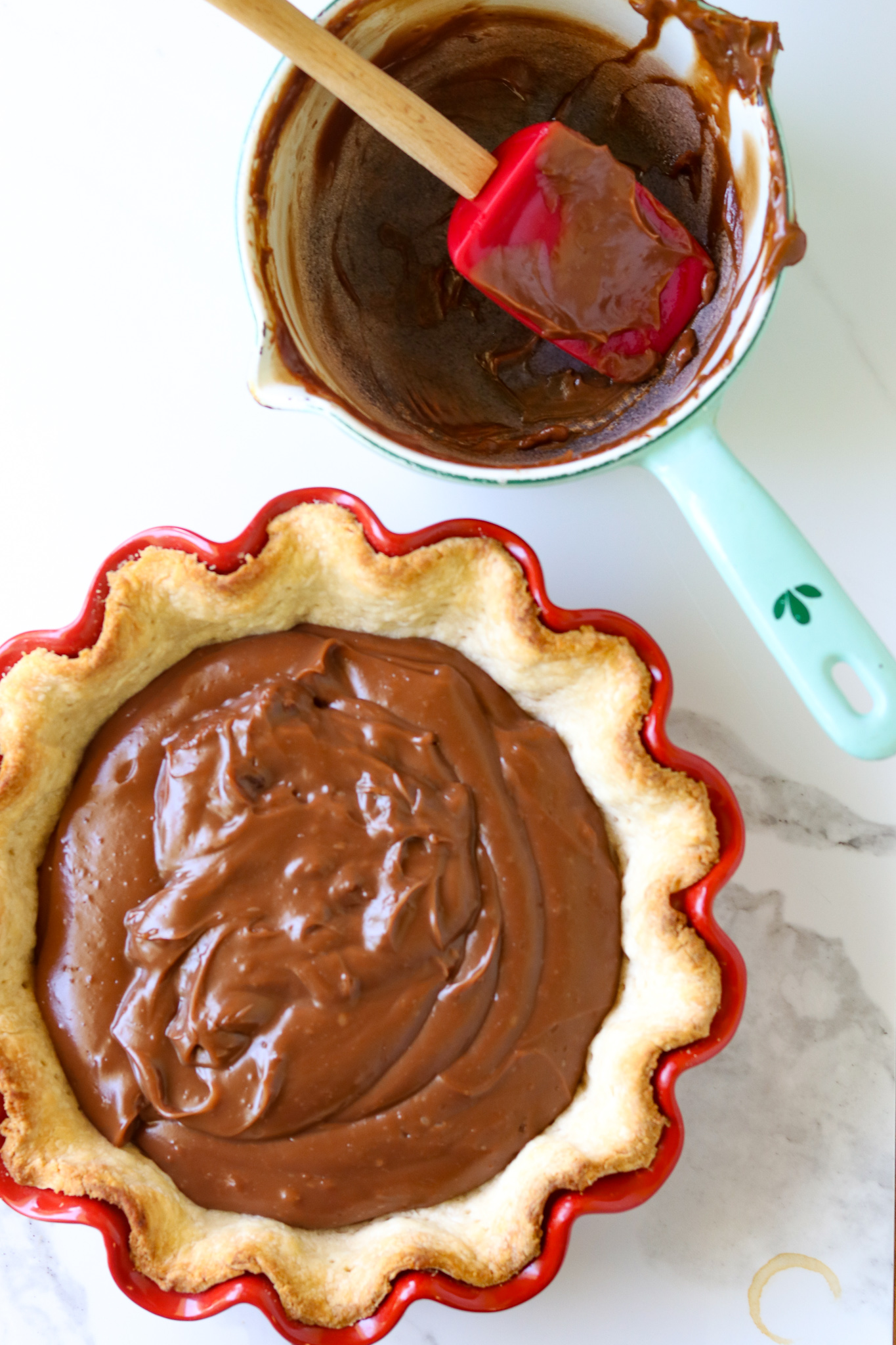 A pie crust filled with Chocolate Bunny pie filling and and empty pan.