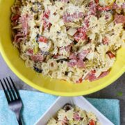 A large bowl and a small bowl of muffuletta pasta salad.