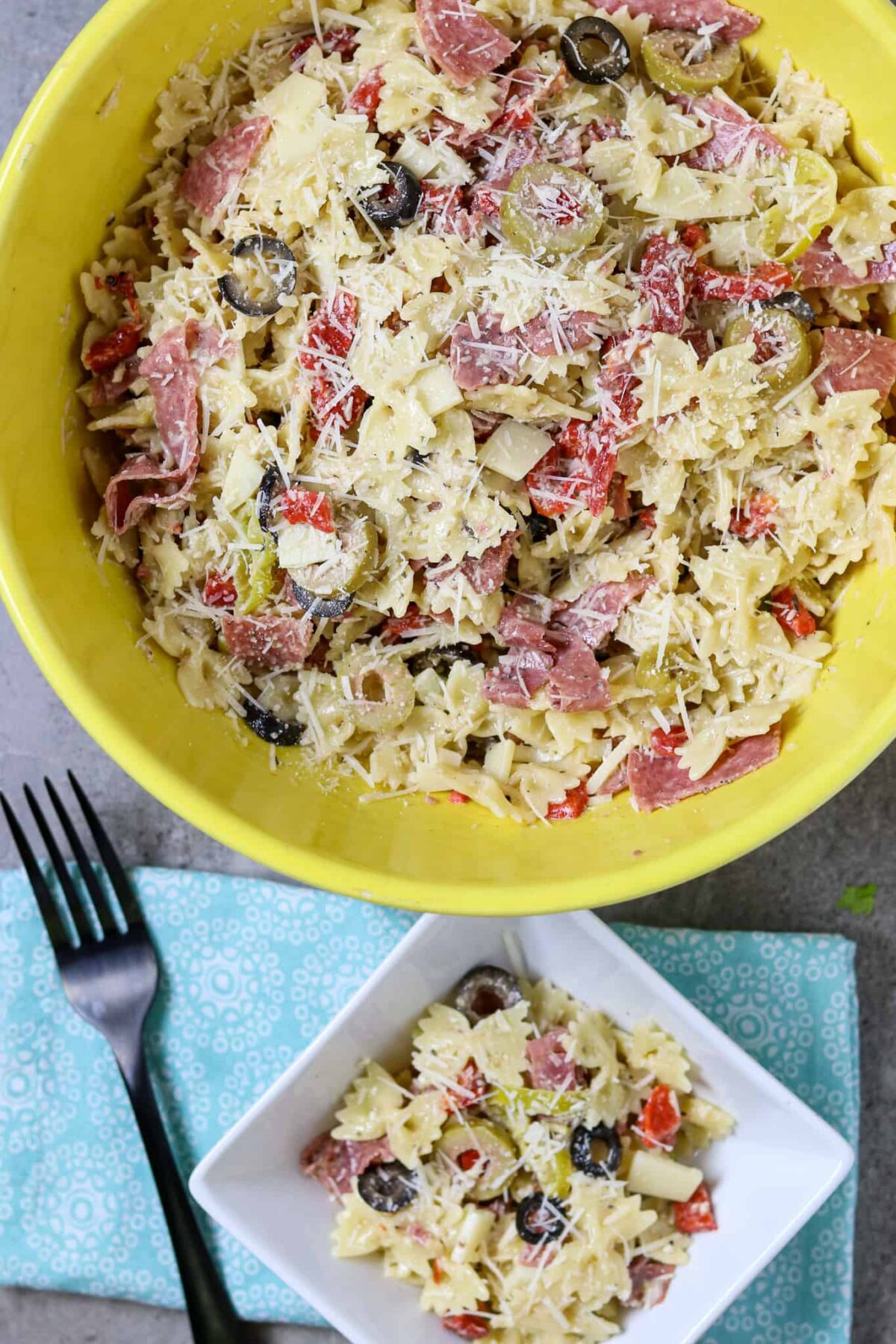 A large bowl and a small bowl of muffuletta pasta salad.