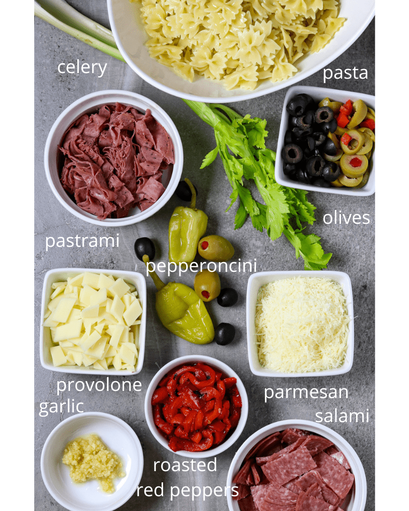 Ingredients of Pasta, meats, cheeses, peppers, olives, and celery.