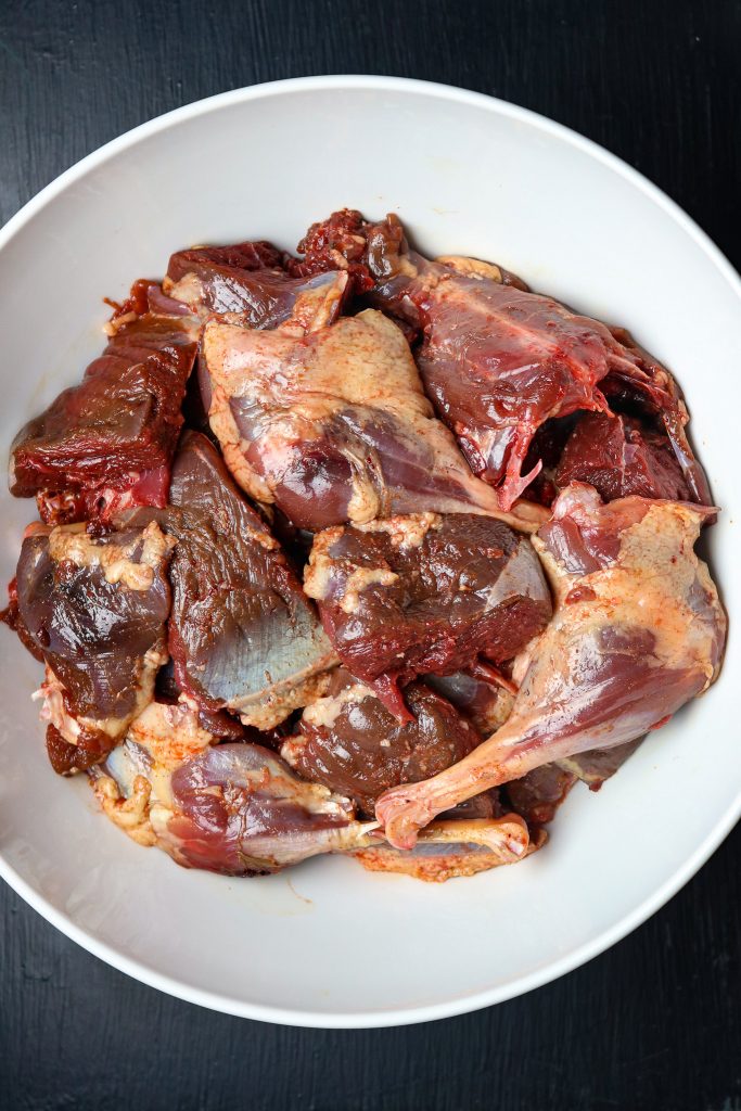 A bowl of cut up raw wild goose meat.