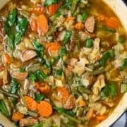 A pot of cabbage soup with andouille sausage for a Pinterest Pin