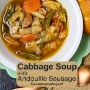 A bowl of Cabbage Soup with Andouille Sausage in a Pinterest Pin.