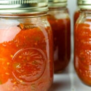 Three jars of homemade tomato salsa.