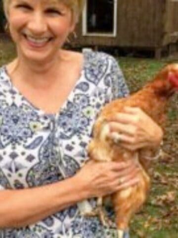 Woman holding a chicken.