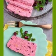 A loaf of frozen cranberry salad sliced with fresh cranberries and mint leaves.