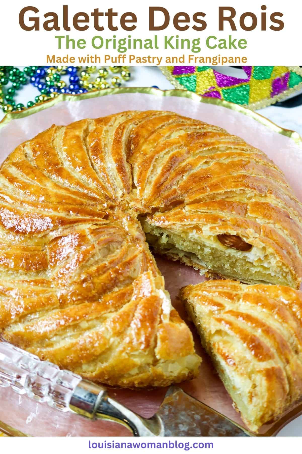 A round pastry cake with a slice cut out exposing a whole almond.