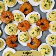 A platter of deviled eggs and shrimp.