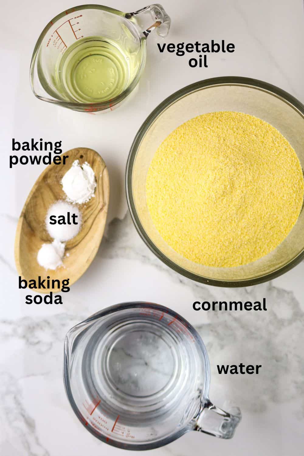 Ingredients for couche couche recipe in idividual glass and wooden container on a white countertop.