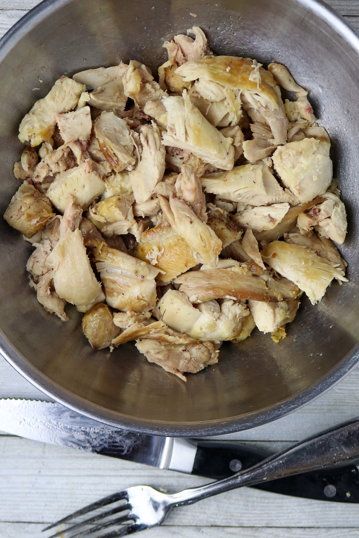 Chicken pieces in an aluminum pan for Chicken and shrimp Jambalaya.