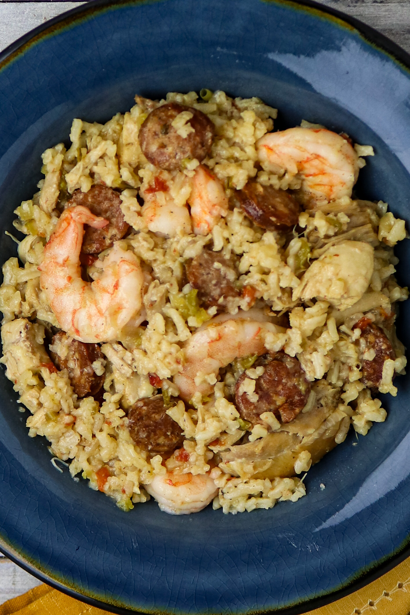 A blue plate of chicken and shrimp jambalaya.