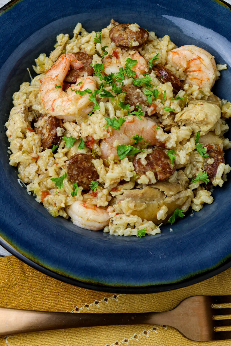 A blue plate of chicken and shrimp jambalaya.