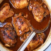 A pot of chicken thighs cooked in a rusty roux gravy for chicken sauce piquant.
