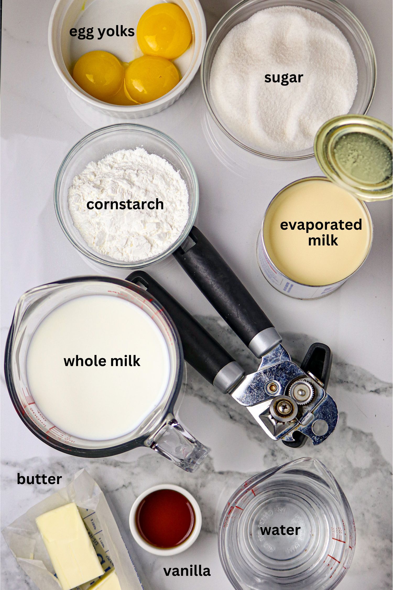 Ingredients of milk, sugar, butter, cornstarch, and vanilla extract for a bouille recipe.