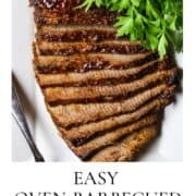 A sliced, cooked beef brisket on a white plate with a bunch of fresh parsley.