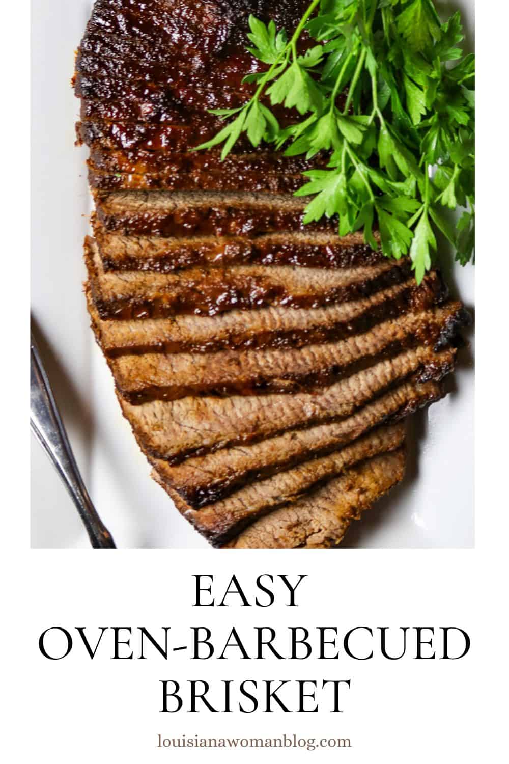 A sliced, cooked beef brisket on a white plate with a bunch of fresh parsley.
