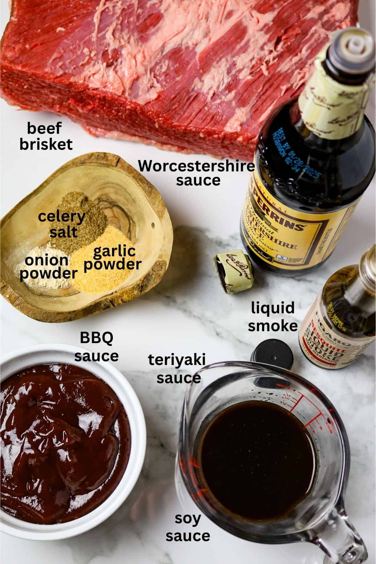 Ingredients of seasonings, barbecue sauce, sauces, and a fresh beef brisket on a white countertop.
