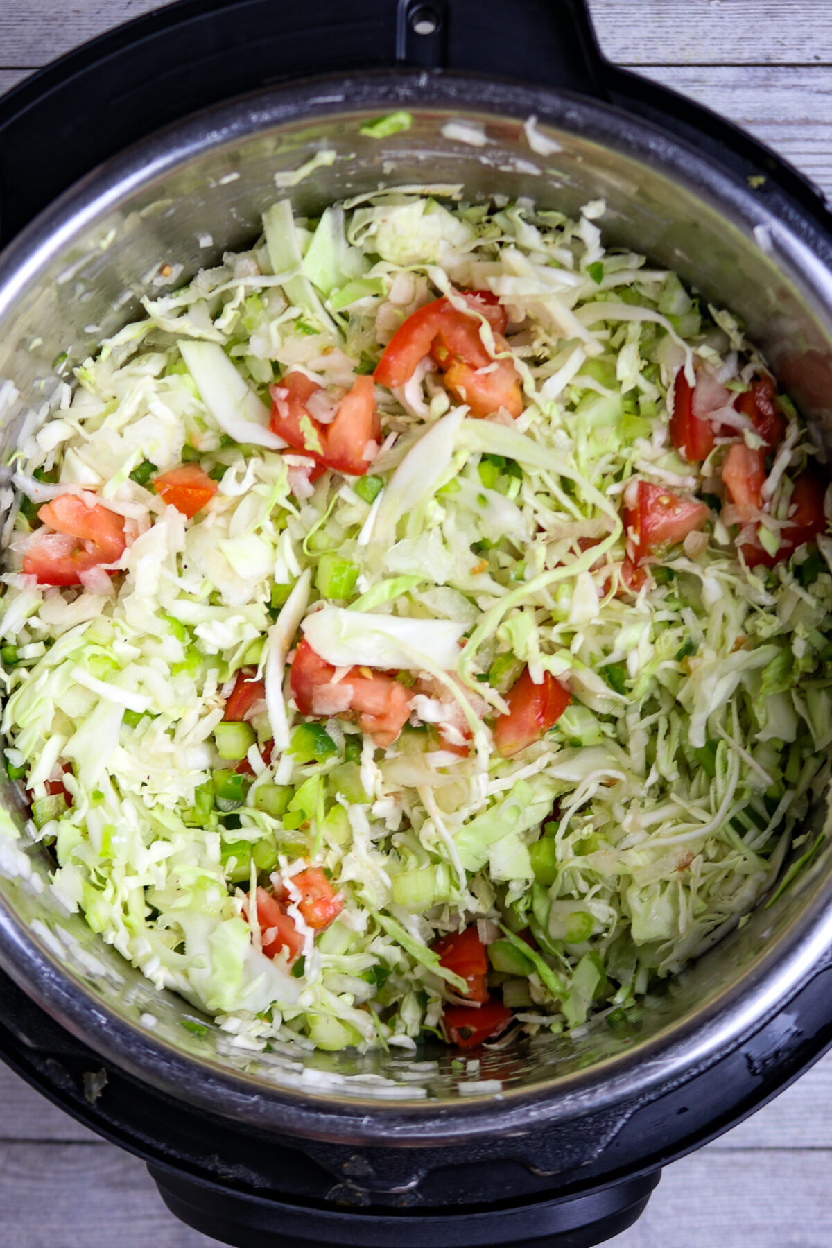 A mixture of raw vegetables in a pot.